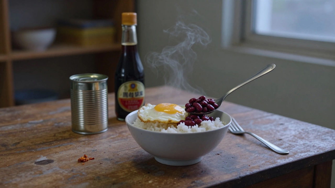 A bowl of rice with fried egg and beans, served simply on a wooden table.